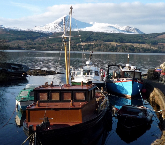 Fishing boats with snow capped Goatfell behind