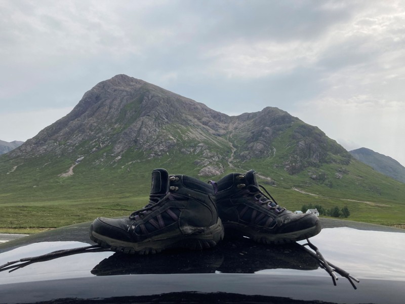 Buachaille Etive Mor mountain with hiking boots in foreground