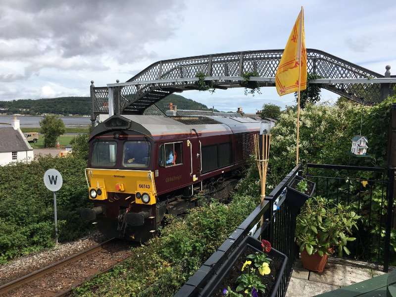 Train passing by the bottom of beer garden at Clachnaharry Inn