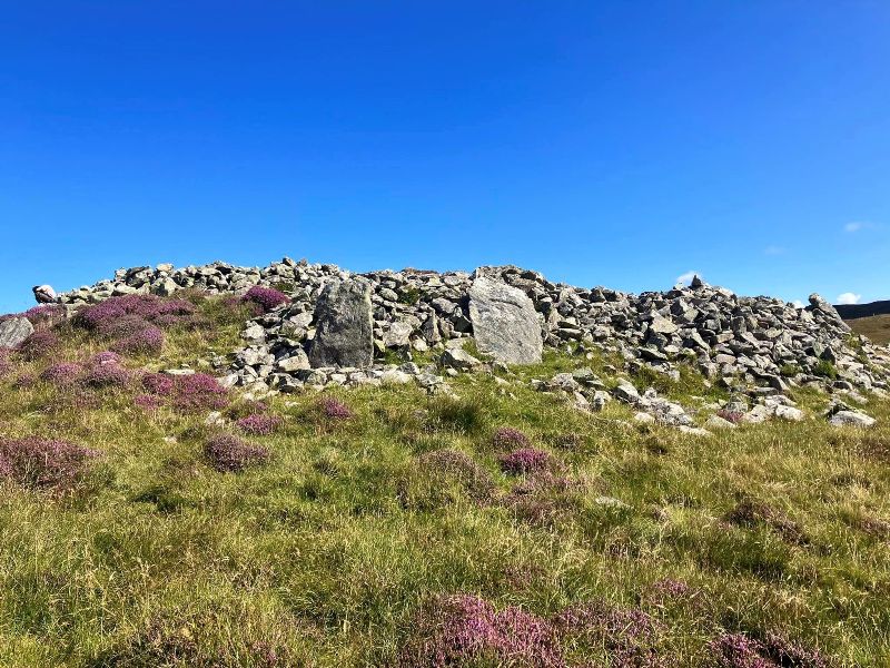 Upright stones that maybe mark old entrance into Dun Bharpa burial cairn