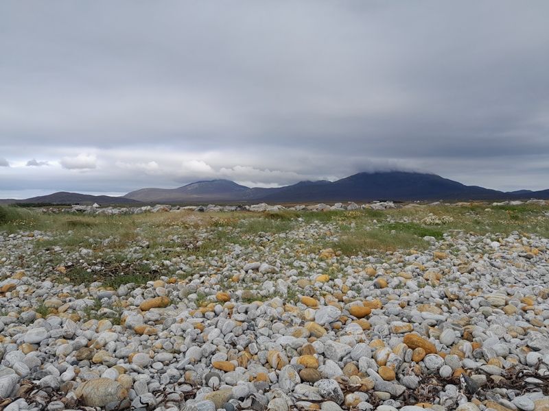 A typical South Uist landscape looking inland across the Machair and Moorland to distant hills.