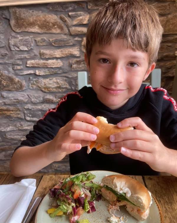 Tucking into a tasty smoked salmon bagel at the Old Post Office cafe in Kincraig