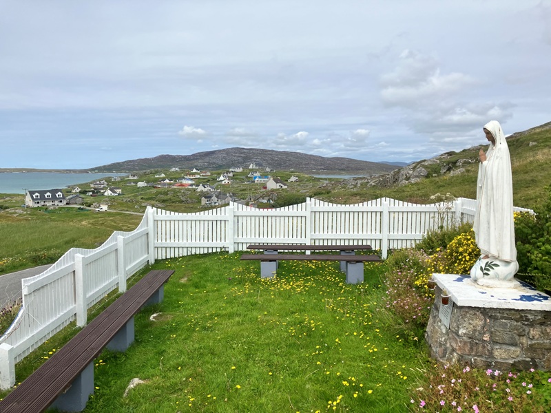 Pink Prince's Flowers growing at the foot of the Virgin Mary statue on Eriskay