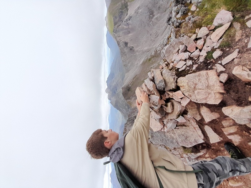 Adding a stone to the Cairn at the summit of Beinn Eighe