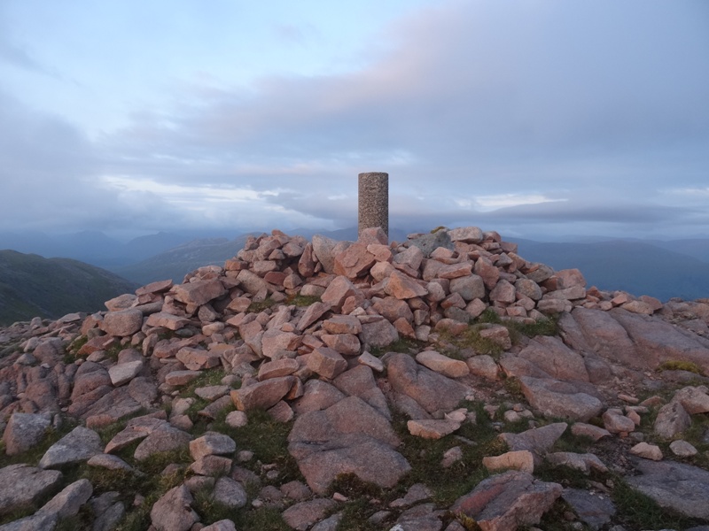 Arriving at the trig point at summit of Creach Bheinn as the sun goes down