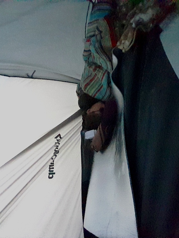 Trying to get comfortable in a tent on a mountainside Trying to get comfortable in a tent on a mountainside